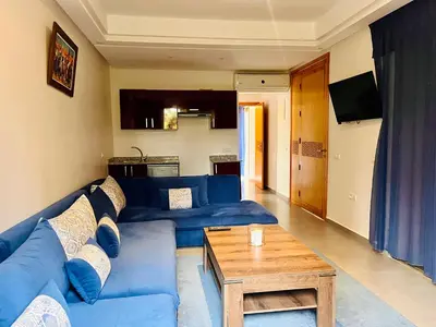 a living room with a blue couch and a table at Hala Luxury Domain in Marrakech