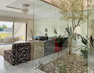 a living room with a glass wall at Hala Luxury Domain in Marrakech