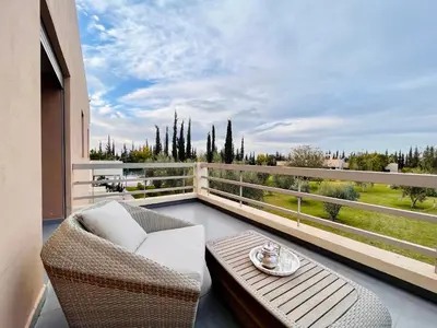 a balcony with a bench and a table and a view at Hala Luxury Domain in Marrakech