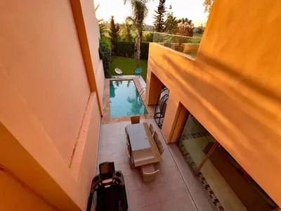 an overhead view of a balcony with a swimming pool at فيلا فاخرة في مراكش مع حديقة خاصة ومسبح - تجربة استرخاء لا تُنسى in Marrakech
