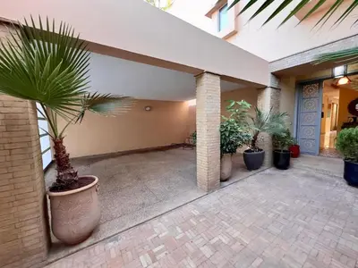 a courtyard with potted plants in a building at فيلا فاخرة في مراكش مع حديقة خاصة ومسبح - تجربة استرخاء لا تُنسى in Marrakech