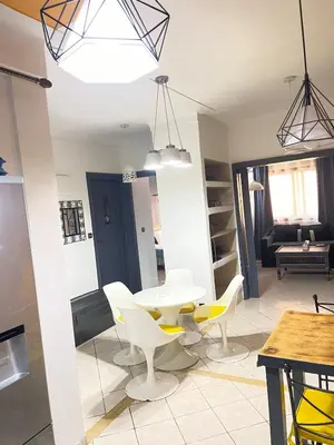 a dining room with a white table and chairs at Comfortable apartment in the center of Gueliz in Marrakech