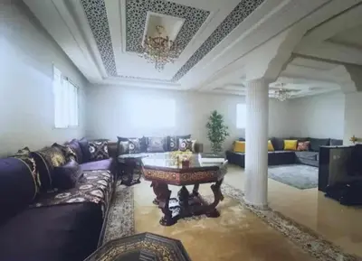 a living room with a couch and a table at appartement meuble in Marrakech