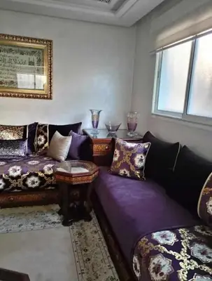 a living room with a couch and a table at appartement meuble in Marrakech