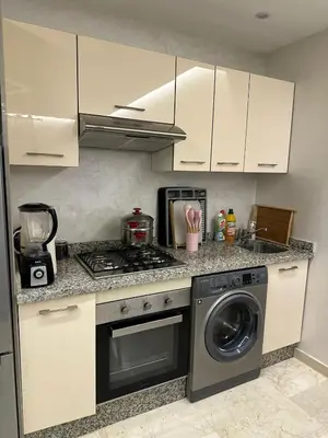 a kitchen with a stove and a washing machine at City Haven at Pearl Garden Pool and View in Marrakech