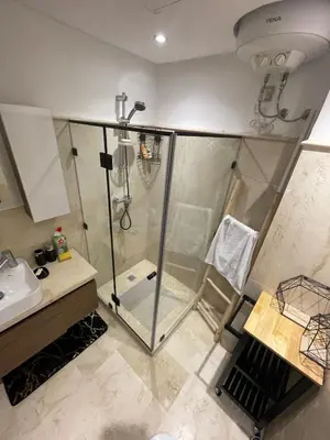 a bathroom with a shower and a sink at City Haven at Pearl Garden Pool and View in Marrakech