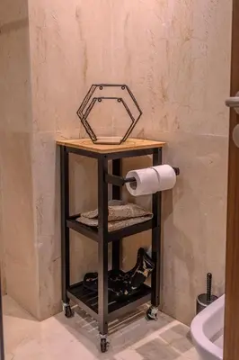 a shelf in a bathroom with a toilet paper at City Haven at Pearl Garden Pool and View in Marrakech