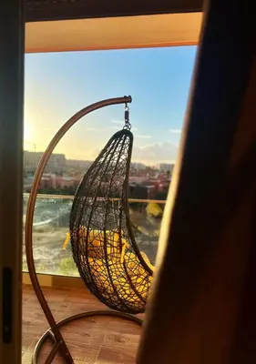 a basket swing in front of a window at City Haven at Pearl Garden Pool and View in Marrakech