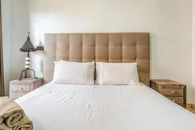 a bedroom with a large bed with white sheets and pillows at Luxury Residence with 2 Terraces Pool and Garden View Security and Self Check-in in Marrakech