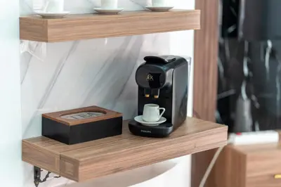 a coffee maker on a wooden shelf with a cup at Luxury Residence with 2 Terraces Pool and Garden View Security and Self Check-in in Marrakech
