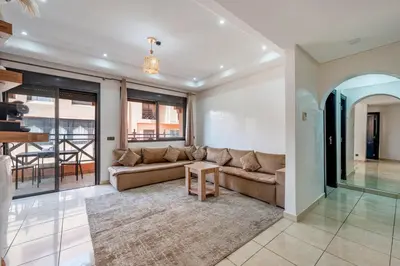 a living room with a couch and a table at Luxury Residence with 2 Terraces Pool and Garden View Security and Self Check-in in Marrakech