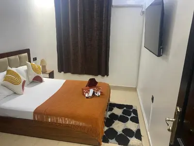 a bedroom with a bed with a tv on the wall at Modern central apartment 2 bedrooms in Marrakech