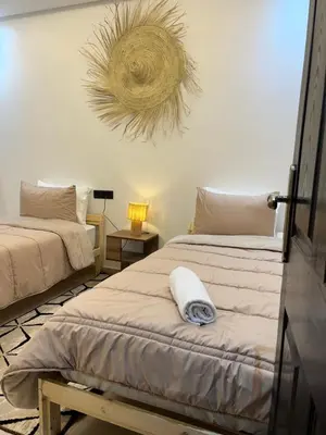 two beds in a room with at Modern central apartment 2 bedrooms in Marrakech