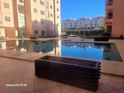 a swimming pool in the middle of a building at Sublime appartement au coeur de Marrakech in Marrakech