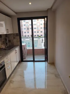 an empty kitchen with a door leading to a pool at Sublime appartement au coeur de Marrakech in Marrakech