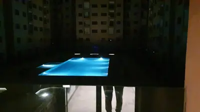 a black table with a blue pool in a room at Sublime appartement au coeur de Marrakech in Marrakech