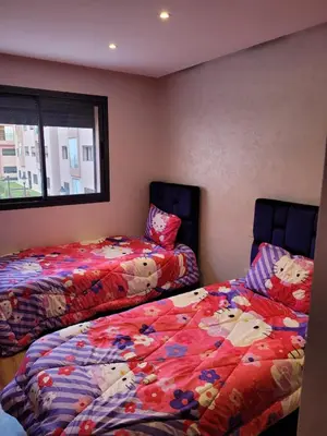 two beds sitting next to each other in a room at Sublime appartement au coeur de Marrakech in Marrakech