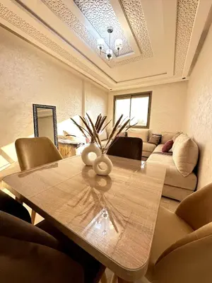 a living room with a table and a couch at New and modern apartment in Marrakech