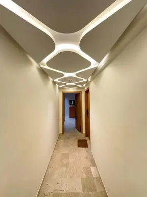 a hallway with a ceiling with lights on it at New and modern apartment in Marrakech