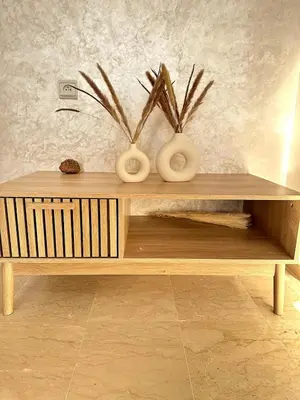 a wooden coffee table with vases on top of it at New and modern apartment in Marrakech