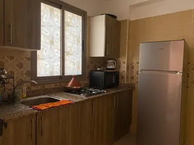 a kitchen with a white refrigerator and a sink at Location appartement a Marrakech aboib gulez in Marrakech