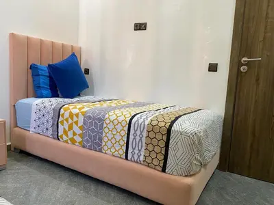 a bed with a bed frame in a room at Location appartement a Marrakech aboib gulez in Marrakech