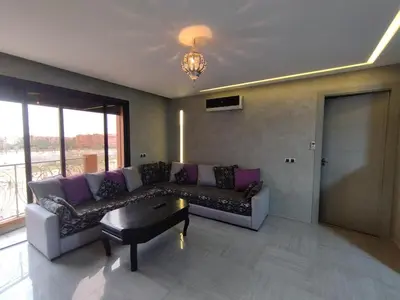 a living room with a couch and a table at Appartement calme, proche de toutes commodités in Marrakech