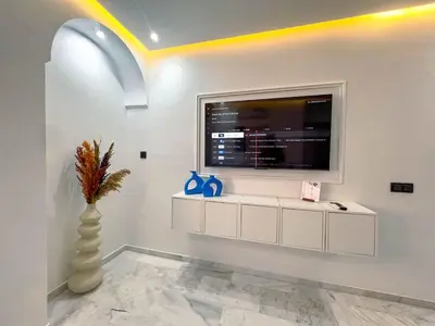 a living room with a large window and a vase at Royal CinemaBedroom Gueliz Center in Marrakech