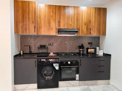 a kitchen with a stove and a washing machine at Royal CinemaBedroom Gueliz Center in Marrakech