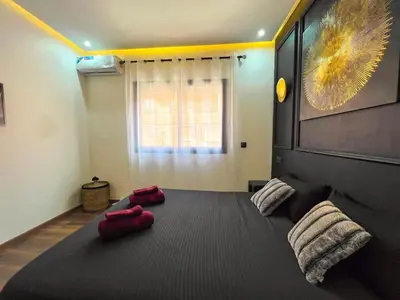 a large bed in a room with red pillows on it at Royal CinemaBedroom Gueliz Center in Marrakech