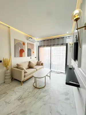 a living room with a couch and a table at Luxe Studio Gueliz in Marrakech