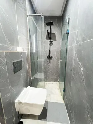 a bathroom with a shower with a toilet and a sink at Luxe Studio Gueliz in Marrakech