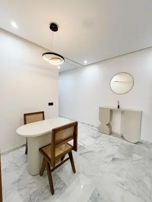 a white room with a table and two chairs at Luxe Studio Gueliz in Marrakech