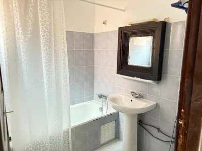a bathroom with a sink and a toilet and a tub at LOGEMENT ENTIER MARRAKECh G26 N 35 in Marrakech