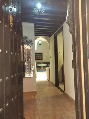 a hallway in a house with wooden walls and doors at LOGEMENT ENTIER MARRAKECh G26 N 35 in Marrakech