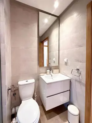 a bathroom with a white toilet and a sink at Prestigia Saphir Luxury 3 Bedrooms, Pool & Golf View, near Airport in Marrakech
