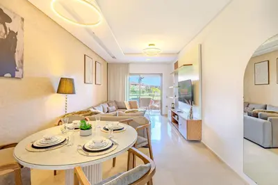 a living room with a table and chairs at Appât hôtel in Marrakech