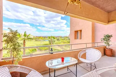 a balcony with a table and chairs and a view at Appât hôtel in Marrakech