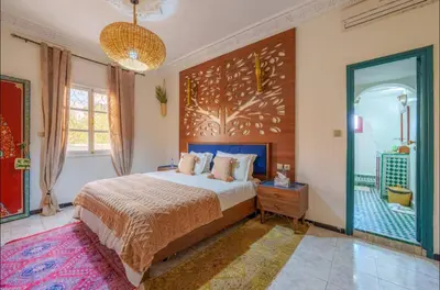 a bedroom with a large bed and a large window at Palais Rhize targa in Marrakech