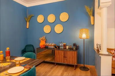 a room with a blue wall with a table and mirrors at Palais Rhize targa in Marrakech