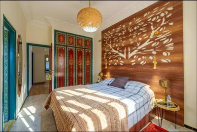 a bedroom with a bed and a wooden wall at Palais Rhize targa in Marrakech