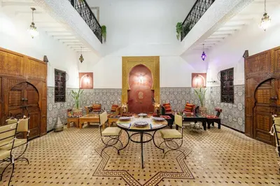 a living room with a table and chairs at Riad Khadoj-Marrakech-Traditional in Marrakech