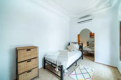 a bedroom with a bed and a dresser at Riad Khadoj-Marrakech-Traditional in Marrakech