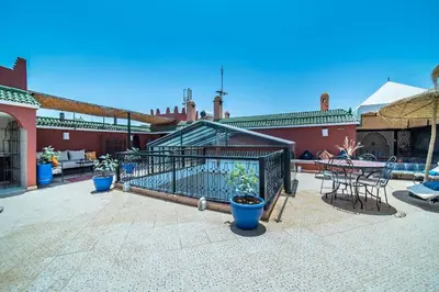 a patio with a fence and a table and chairs at Riad Khadoj-Marrakech-Traditional in Marrakech