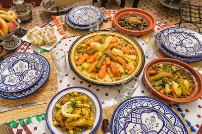 a table topped with blue and white plates of food at Riad Khadoj-Marrakech-Traditional in Marrakech