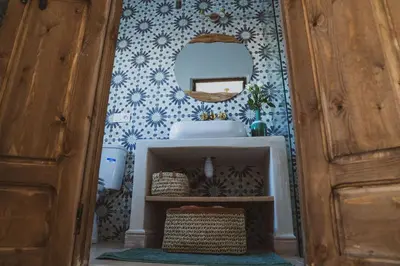 a bathroom with a sink and a mirror on a wall at Riad Yuna in Marrakech