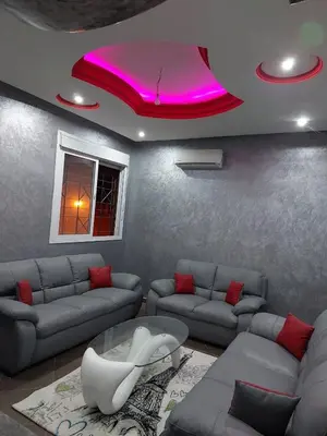 a living room with a couch and a table at Furnished apartment close to the city center in Marrakech