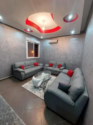 a living room with two couches and a table at Furnished apartment close to the city center in Marrakech