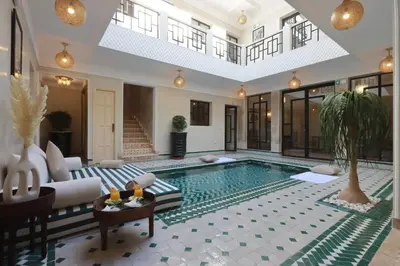 a swimming pool in a living room with a villa at Riad Valentine in Marrakech