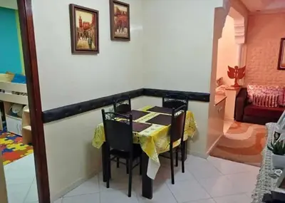 a dining room with a table and some chairs at appartement meuble in Marrakech
